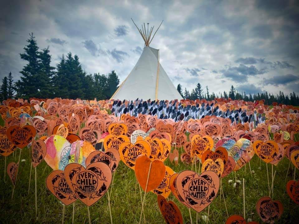 Community members painting Every Child Matters art panels