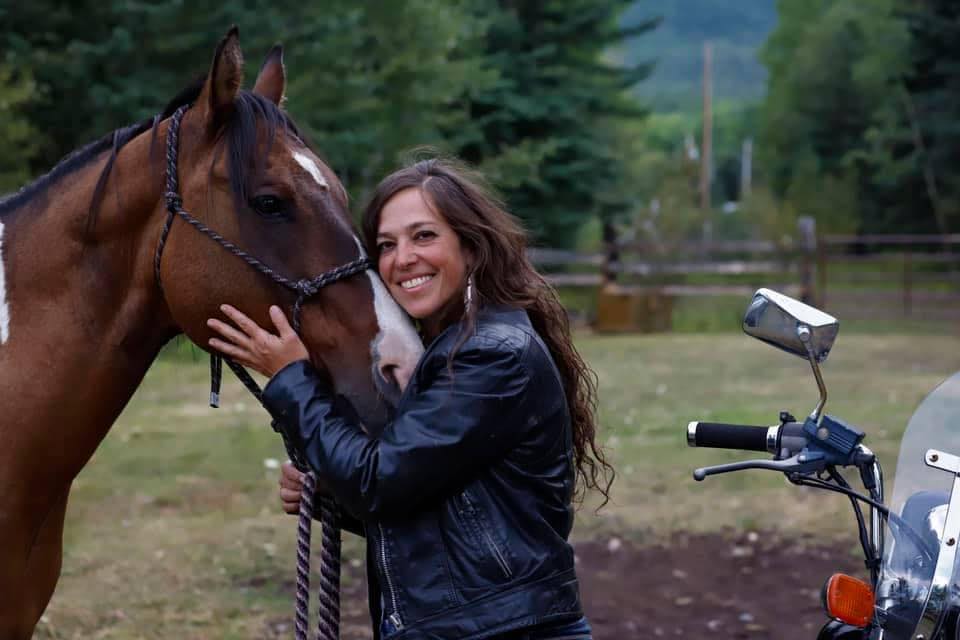 Kristin Braun with her camera and horse