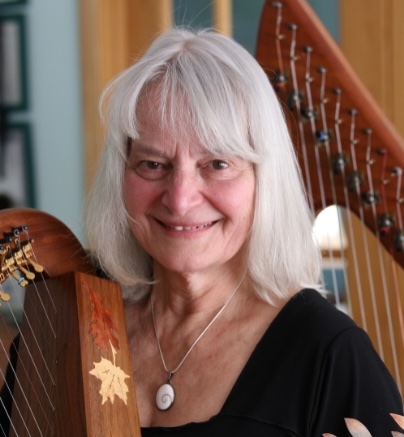Marilyn Bulger smiling beside her harp